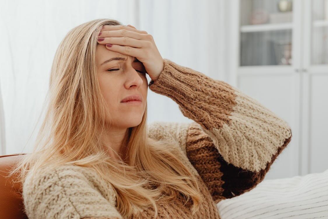 Woman holding her head in pain