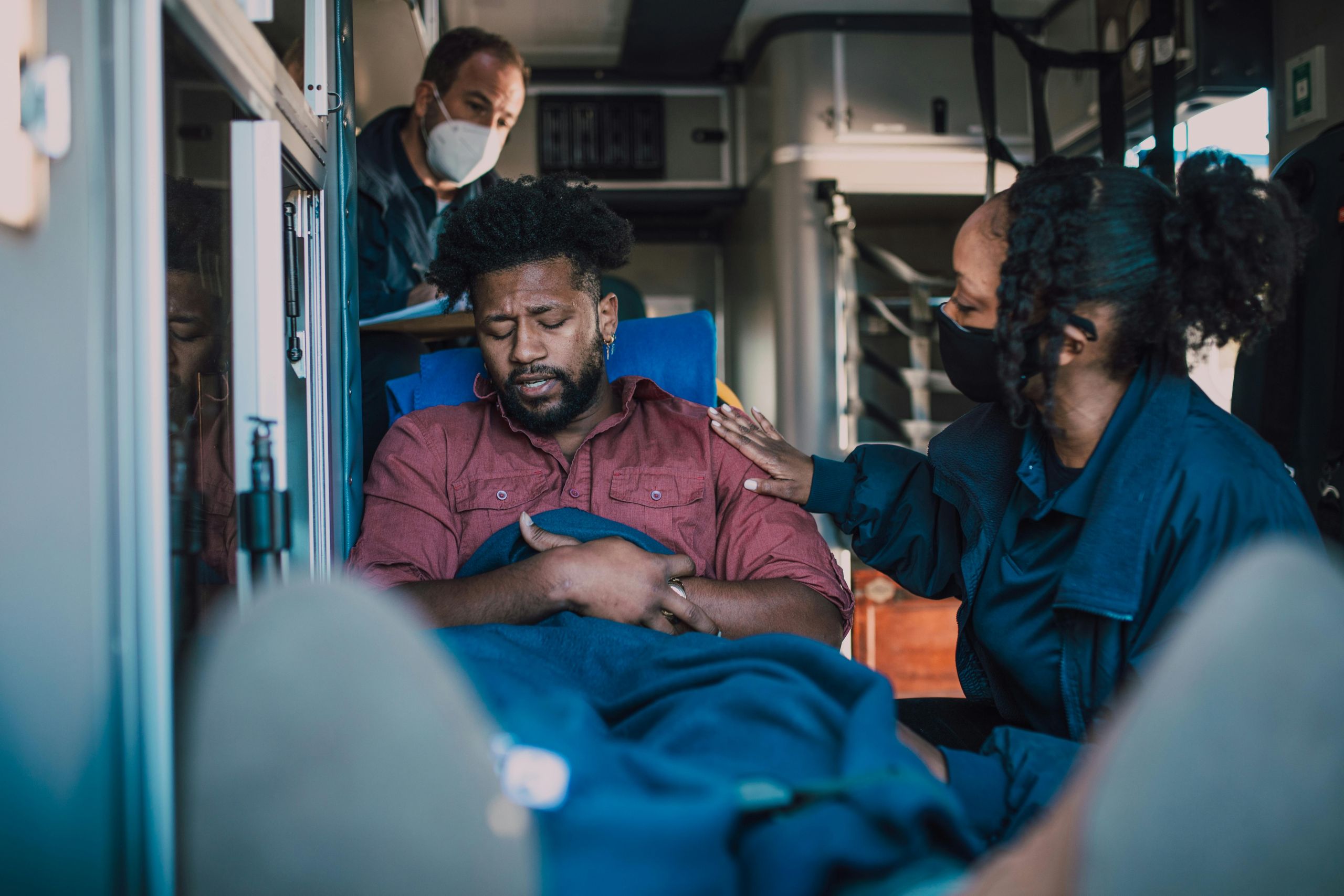 paramedics tending to injured person in back of ambulance