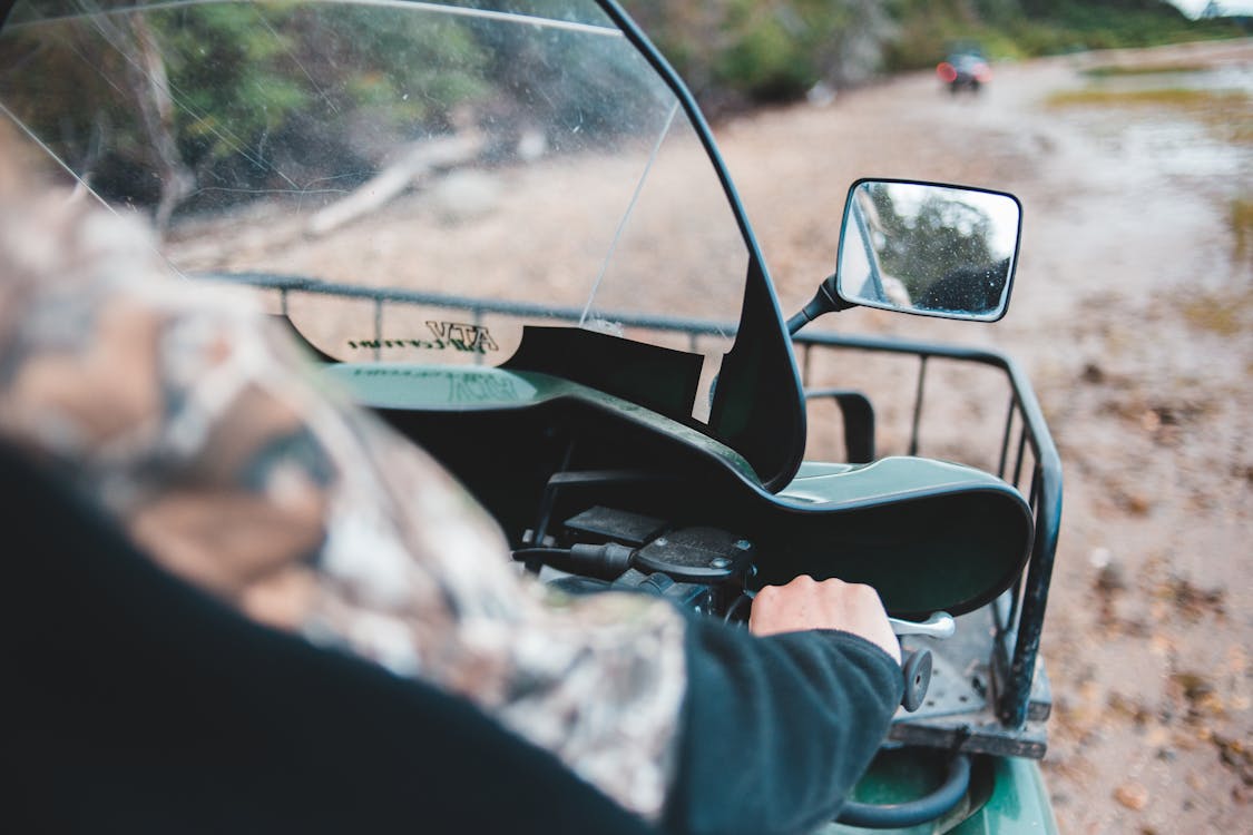 over-the-shoulder view of person riding all terrain vehicle