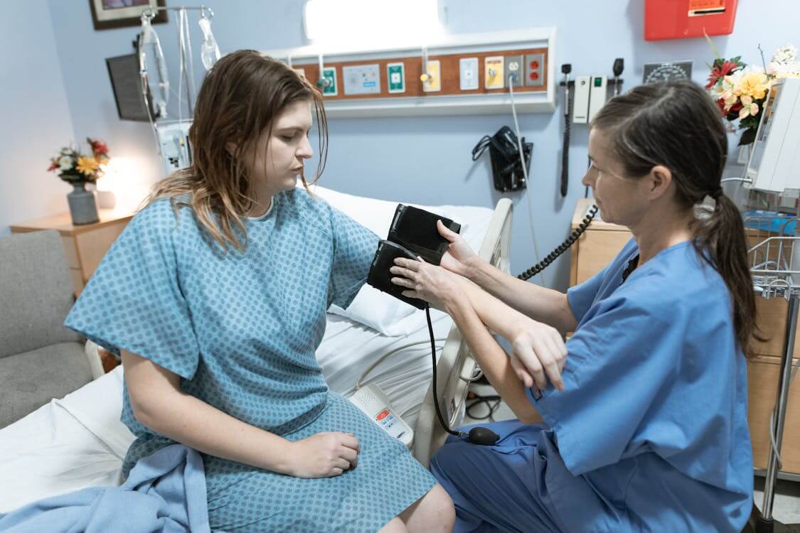 nurse measuring patient’s blood pressure