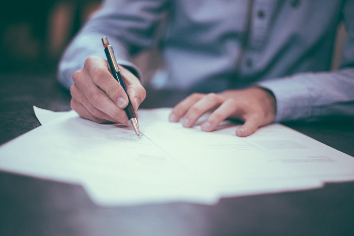 A person writing out paperwork