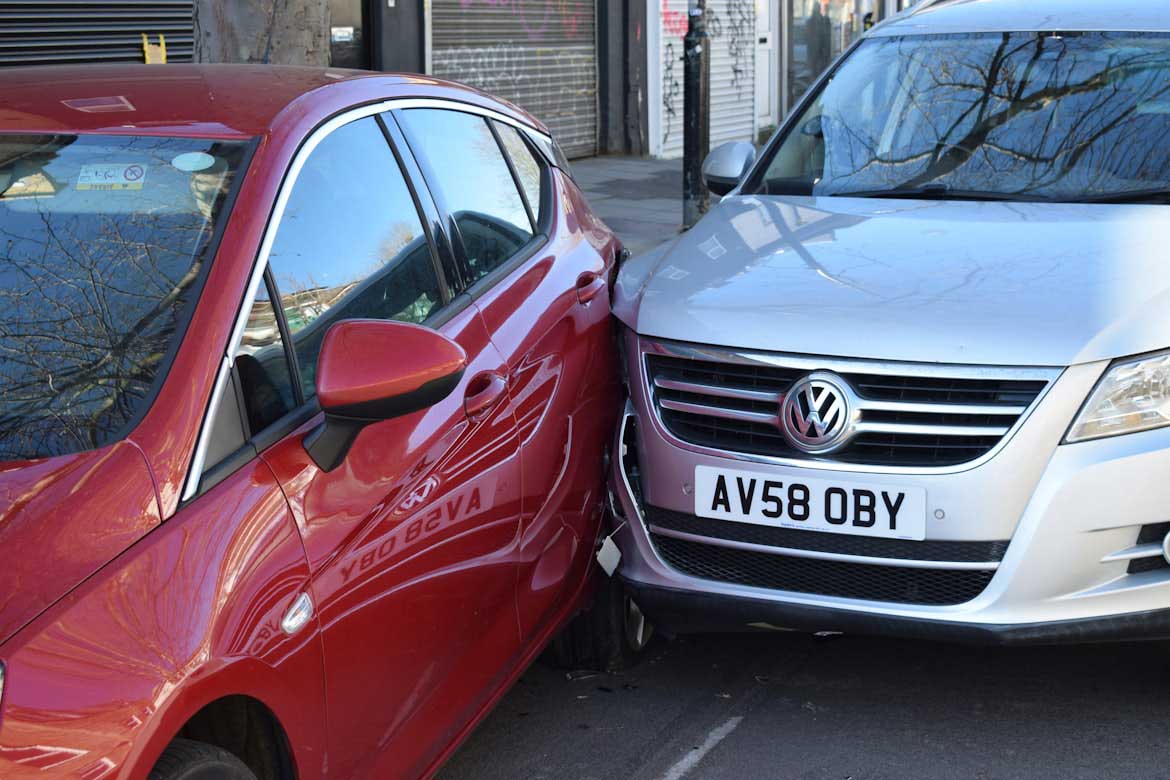 A picture of two cars crashed into each other