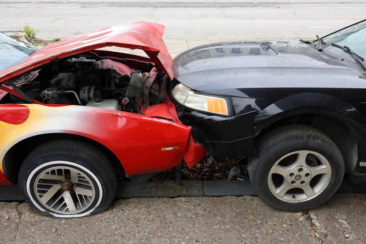 A red and black car in a fender bender